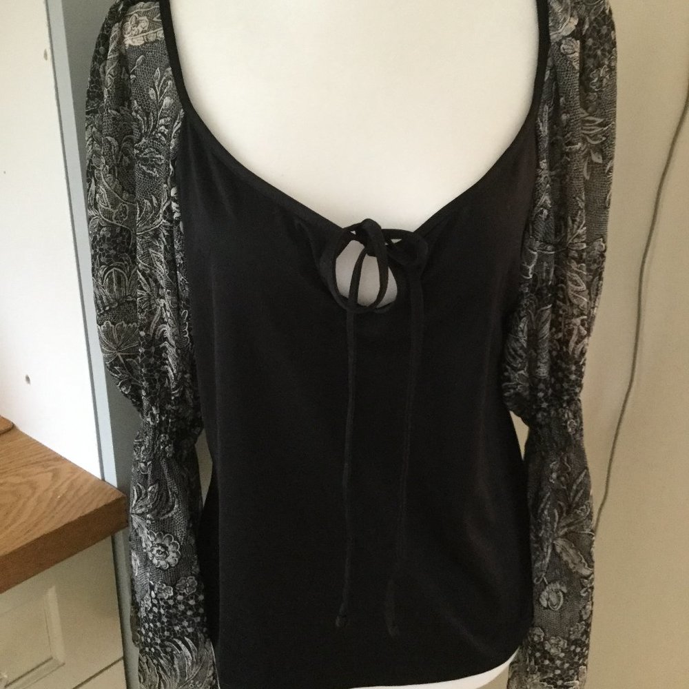 Top black with sheer floral sleeves size large sleeves have sheering at elbow
